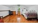Bright bedroom featuring hardwood floors, a bed, desk, and natural light from the window at 7204 E 218 Hwy, Marshville, NC 28103