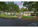 Charming single story home with lush landscaping and a welcoming covered patio at 7204 E 218 Hwy, Marshville, NC 28103