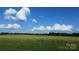 Expansive farmland with a clear blue sky and fluffy clouds showcases natural beauty at 7204 E 218 Hwy, Marshville, NC 28103