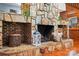 Close-up of a stunning stone fireplace with rustic details, wood storage, and decorative accents at 7204 E 218 Hwy, Marshville, NC 28103