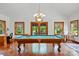 Bright game room featuring a billiard table, hardwood floors, and natural light streaming through large windows at 7204 E 218 Hwy, Marshville, NC 28103