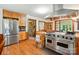 Bright kitchen features wood cabinets, a large stainless steel refrigerator, and an industrial-style oven and vent at 7204 E 218 Hwy, Marshville, NC 28103