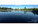 Picturesque lake view with lush greenery reflected in the still, blue water at 7204 E 218 Hwy, Marshville, NC 28103