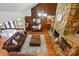 Spacious living room features hardwood floors, a stone fireplace, and comfortable sofas at 7204 E 218 Hwy, Marshville, NC 28103