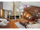 Cozy living room with a floor-to-ceiling stone fireplace, hardwood floors, and comfortable leather seating at 7204 E 218 Hwy, Marshville, NC 28103