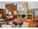 Spacious living room with a stone fireplace, hardwood floors, and rustic wood paneling that enhances the room's ambiance at 7204 E 218 Hwy, Marshville, NC 28103