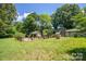 Backyard with a stone well and fenced-off patio area at 749 N Miller Ave, Statesville, NC 28677