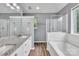 Bathroom featuring a double vanity, a bathtub, and a glass shower at 8120 Vermilion Dr, Charlotte, NC 28215