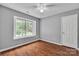 Bedroom featuring hardwood floors, a ceiling fan, and a large window at 8120 Vermilion Dr, Charlotte, NC 28215