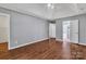 Empty bedroom featuring hardwood floors, a ceiling fan, and an ensuite bathroom at 8120 Vermilion Dr, Charlotte, NC 28215
