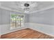 Light-filled dining room with hardwood floors and modern lighting fixture at 8120 Vermilion Dr, Charlotte, NC 28215