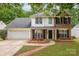 Charming two-story home featuring a brick and white facade, black shutters, and a well-manicured lawn at 8120 Vermilion Dr, Charlotte, NC 28215