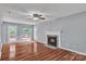 Cozy living room featuring a fireplace, ceiling fan and hardwood floors, with a view to the back deck at 8120 Vermilion Dr, Charlotte, NC 28215