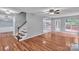 A bright living room with hardwood floors, a staircase and view to the outside deck at 8120 Vermilion Dr, Charlotte, NC 28215