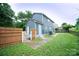 Fenced backyard with small concrete area, lawn, and a gray exterior at 8125 Sheringham Way, Charlotte, NC 28227