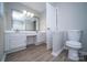 Bathroom featuring a double sink vanity, toilet, and bathtub at 8125 Sheringham Way, Charlotte, NC 28227