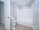 Bright bathroom featuring tile surround shower and tub combination at 8125 Sheringham Way, Charlotte, NC 28227