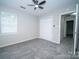 Bedroom showcasing a ceiling fan, window, and closet at 8125 Sheringham Way, Charlotte, NC 28227