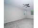 Newly carpeted bedroom with two windows, fresh paint and a modern ceiling fan at 8125 Sheringham Way, Charlotte, NC 28227
