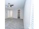 Open, empty carpeted room with neutral paint, a ceiling fan, and access to a bathroom at 8125 Sheringham Way, Charlotte, NC 28227