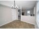 Dining room with chandelier, adjacent to the living area, offering a connected living space at 8125 Sheringham Way, Charlotte, NC 28227