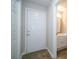 The front entryway of this home has a door to a half bath and tan tile floors at 8125 Sheringham Way, Charlotte, NC 28227
