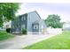 Well-maintained home with a gray exterior, concrete driveway, mature trees, and manicured lawn at 8125 Sheringham Way, Charlotte, NC 28227