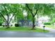 Charming two-story home with a well-manicured lawn, mature trees, and inviting curb appeal at 8125 Sheringham Way, Charlotte, NC 28227