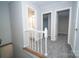 Hallway with neutral paint and new carpet leading to the bathroom and two bedrooms at 8125 Sheringham Way, Charlotte, NC 28227