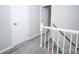 Upstairs hallway with fresh white paint and new gray carpet, plus a wooden handrail at 8125 Sheringham Way, Charlotte, NC 28227