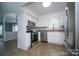Well-lit kitchen featuring stainless steel appliances, white cabinetry, and tile flooring at 8125 Sheringham Way, Charlotte, NC 28227