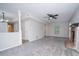 Cozy living room with a brick fireplace, ceiling fan, and neutral tones at 8125 Sheringham Way, Charlotte, NC 28227
