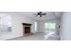 Bright living room featuring a cozy fireplace, neutral paint, and sliding glass door to the backyard at 8125 Sheringham Way, Charlotte, NC 28227