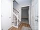 Welcoming foyer with carpeted stairs and white railing leading to the upper level of the home at 8125 Sheringham Way, Charlotte, NC 28227