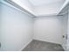 A walk-in closet with gray carpet, white walls and a shelf at 8125 Sheringham Way, Charlotte, NC 28227