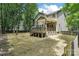 Backyard featuring a deck, stairs, and lawn with natural privacy from the trees at 8521 Aspen Ct, Charlotte, NC 28227