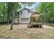Backyard featuring a covered deck, a lawn, and mature trees at 8521 Aspen Ct, Charlotte, NC 28227