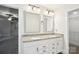 Bathroom featuring double sinks with granite counters and elegant mirrors at 8521 Aspen Ct, Charlotte, NC 28227