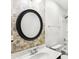 Bathroom features a round mirror, mosaic tile, and a shower-tub combo at 8521 Aspen Ct, Charlotte, NC 28227