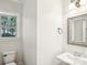Bright bathroom features shiplap walls, stylish mirror, modern fixtures and a view from the window at 8521 Aspen Ct, Charlotte, NC 28227