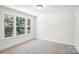 Bedroom featuring carpet, trim, and natural light from the windows at 8521 Aspen Ct, Charlotte, NC 28227