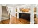Open kitchen area with a granite countertop bar overlooking the stairs and dining area at 8521 Aspen Ct, Charlotte, NC 28227