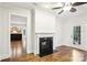 Living room featuring hardwood floors, fireplace, and access to the kitchen and outdoor patio at 8521 Aspen Ct, Charlotte, NC 28227