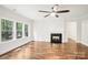 Bright living room with hardwood floors, fireplace and large windows overlooking trees at 8521 Aspen Ct, Charlotte, NC 28227
