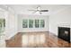 Open living room with hardwood floors, fireplace and large windows bring in natural light at 8521 Aspen Ct, Charlotte, NC 28227