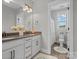 Well-lit bathroom with double sinks, white cabinets, and a separate toilet room with shower/tub combo at 909 Herrons Ferry Rd, Rock Hill, SC 29730