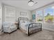 Comfortable bedroom with a decorative ceiling fan, plush bedding, and sunny windows at 909 Herrons Ferry Rd, Rock Hill, SC 29730
