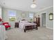 Charming bedroom with a large bed and antique furniture with natural light coming through the windows at 909 Herrons Ferry Rd, Rock Hill, SC 29730