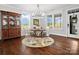 Bright dining room with a round table, bench seating, chandelier, and views of the landscaped yard at 909 Herrons Ferry Rd, Rock Hill, SC 29730