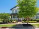 Charming two-story home featuring landscaped front yard with mature trees at 909 Herrons Ferry Rd, Rock Hill, SC 29730